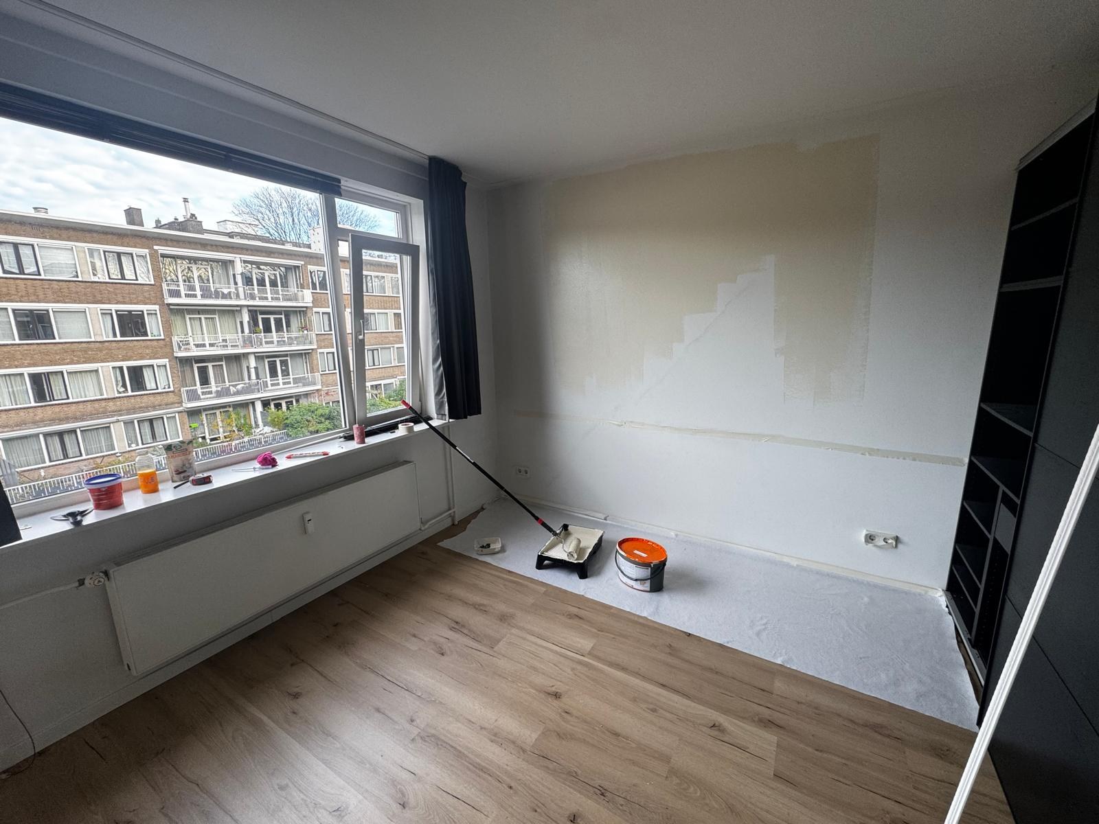 Room prepared for painting with covered floors and taped edges — Amsterdam apartment